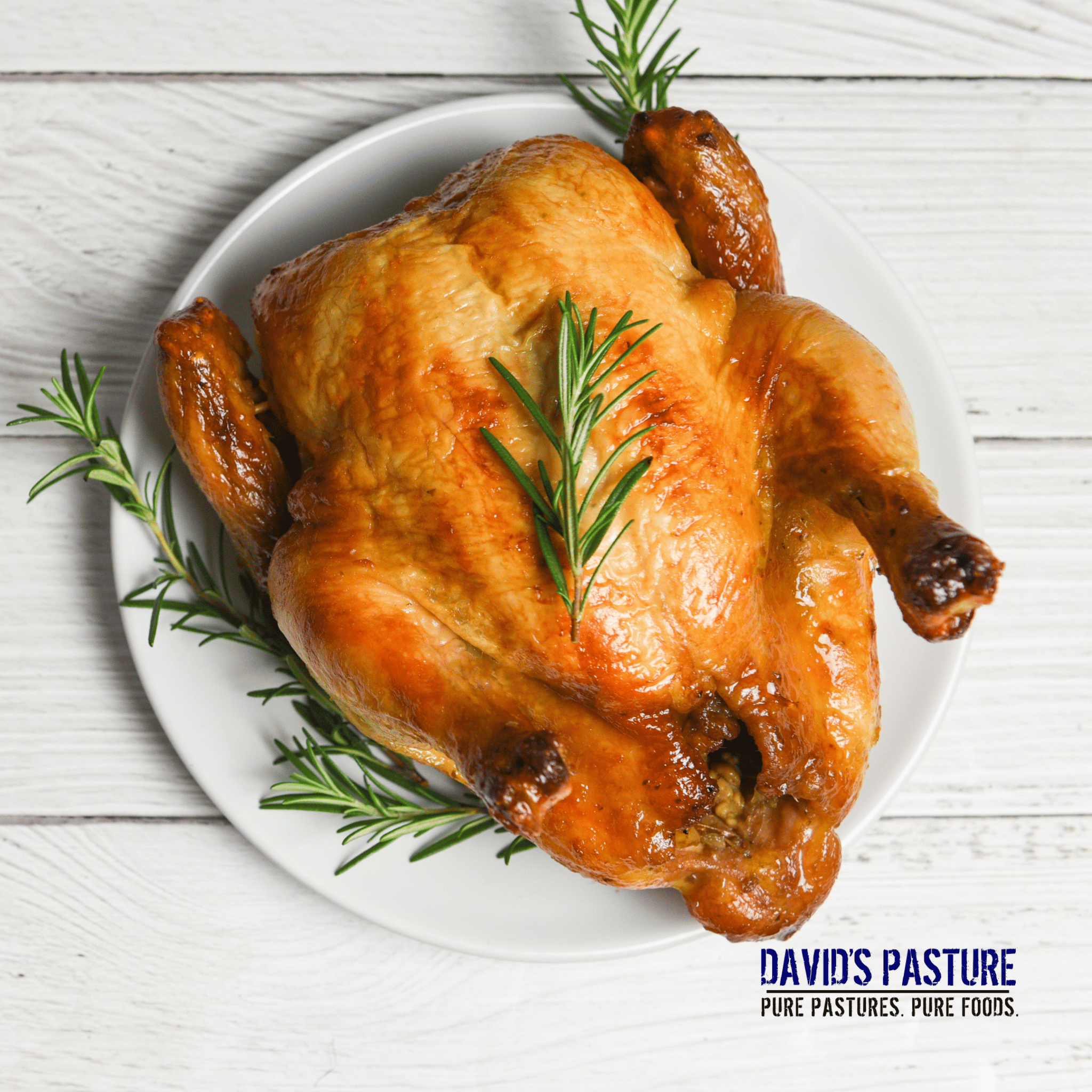Roasted pasture-raised whole chicken served with herbs and vegetables
