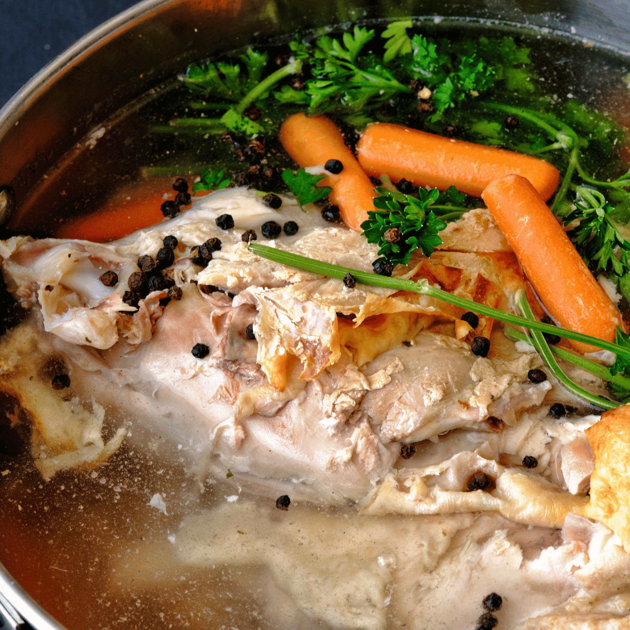 Pasture raised chicken necks simmering in pot for broth