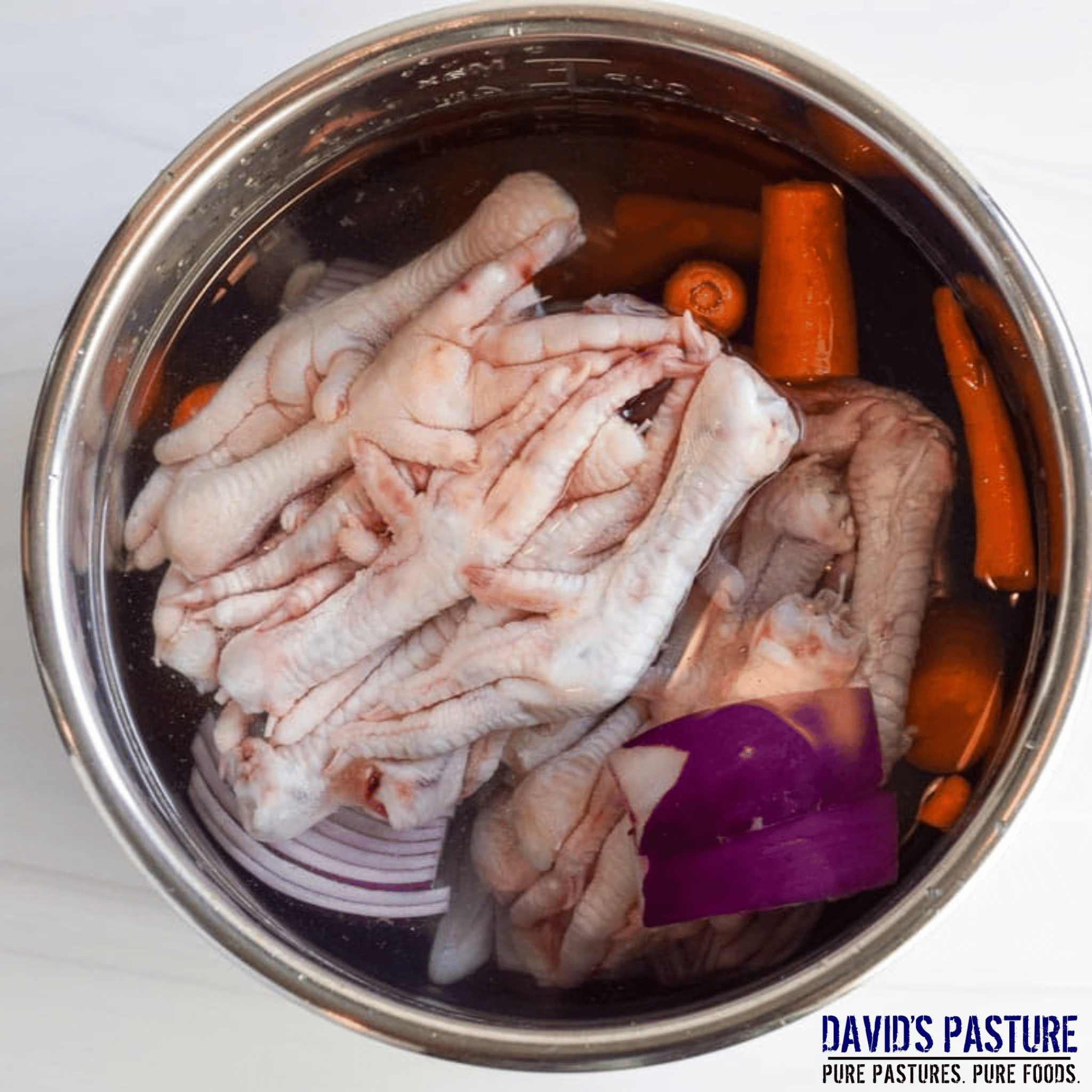Pasture raised chicken feet simmering in pot for bone broth
