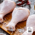 Raw chicken legs on a wooden cutting board with salt and red peppers, featuring the Campo Lindo logo.