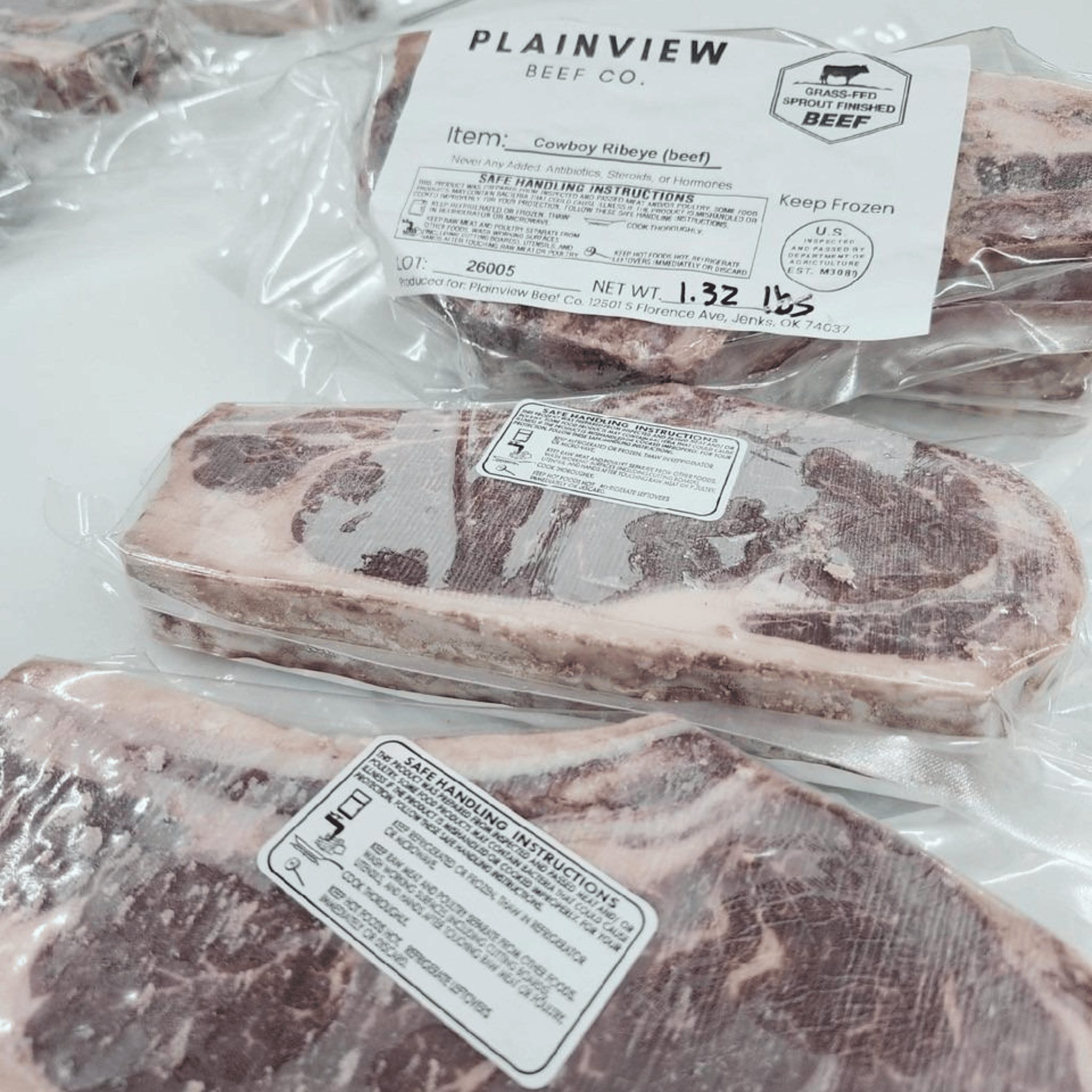 Raw beef ribs with Plainview Beef Co. packaging on a white surface
