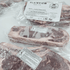Raw beef ribs with Plainview Beef Co. packaging on a white surface