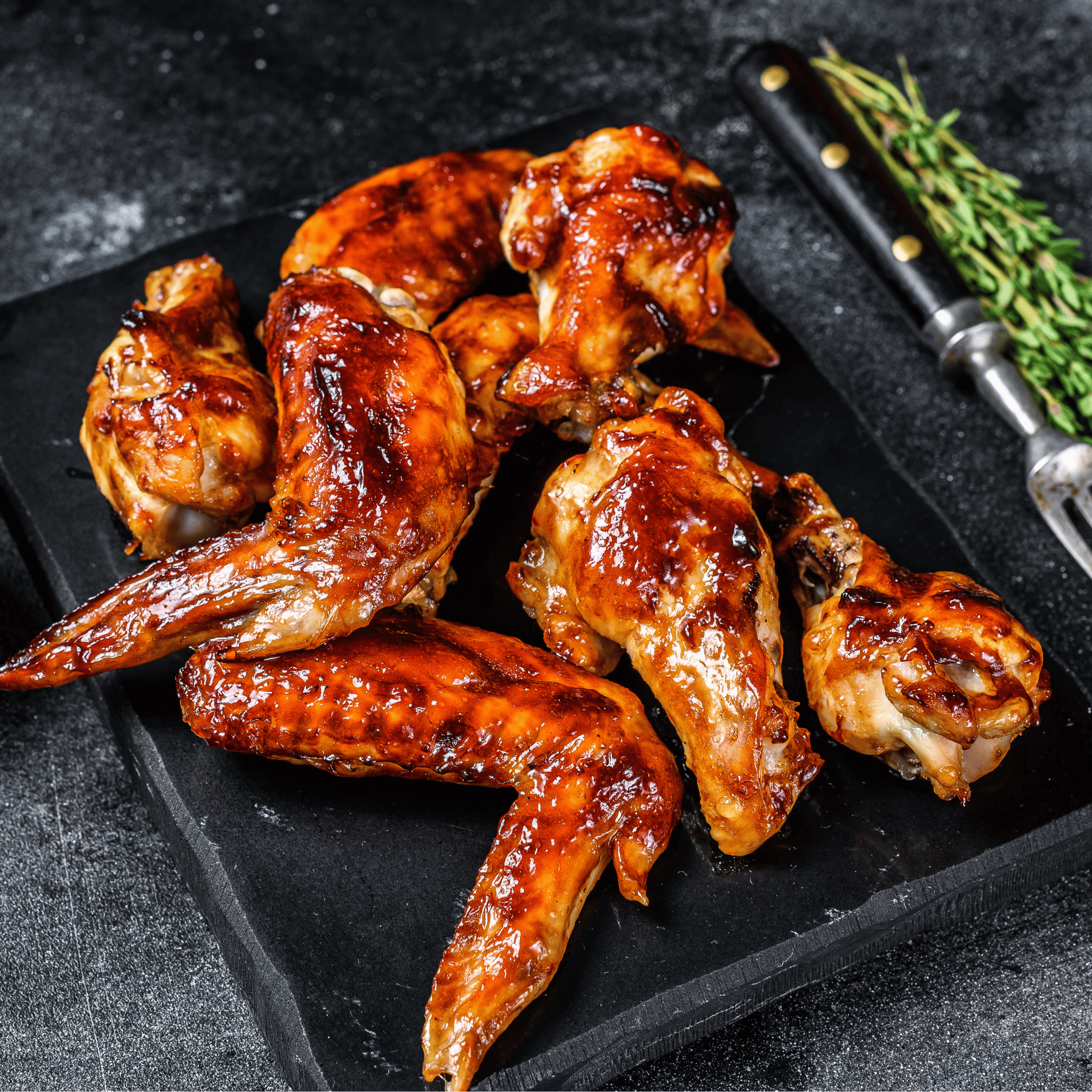 Crispy pasture-raised chicken wings tossed in sauce