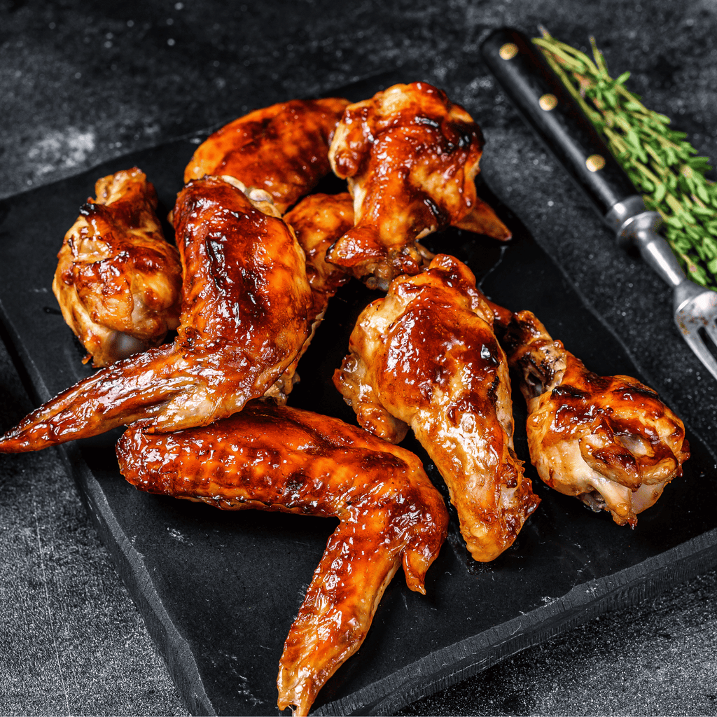 Crispy pasture-raised chicken wings tossed in sauce