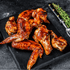 Crispy pasture-raised chicken wings tossed in sauce