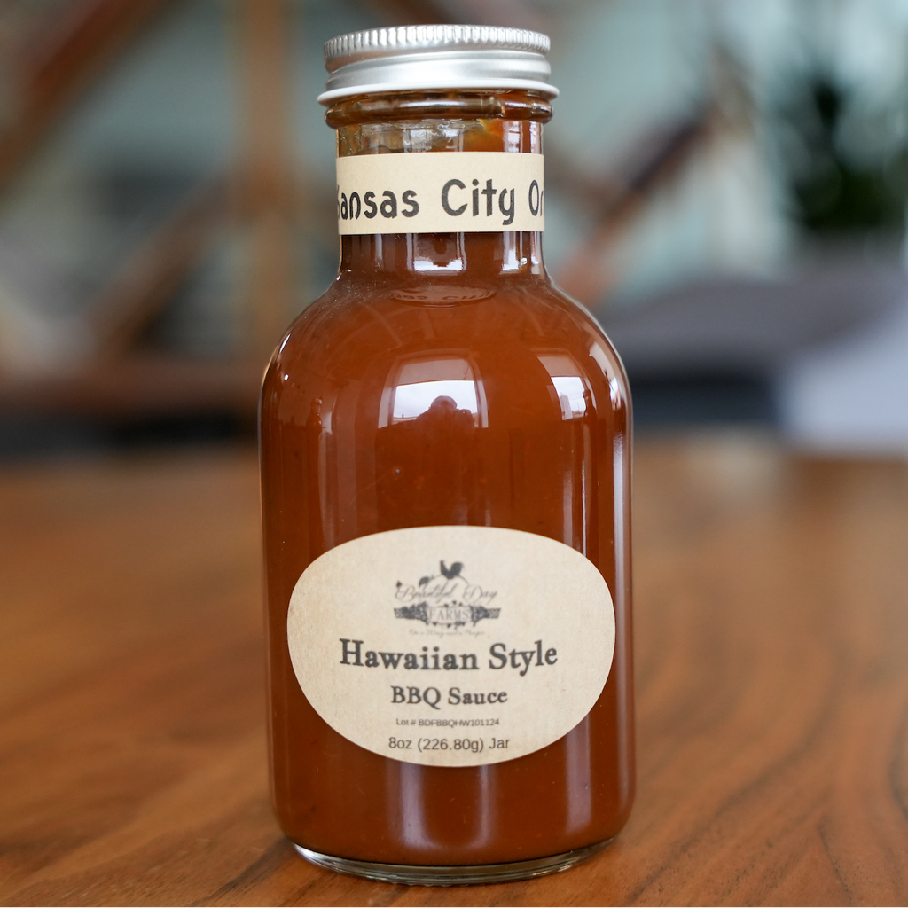 Bottle of Kansas City O Hawaiian Style BBQ Sauce on a wooden surface